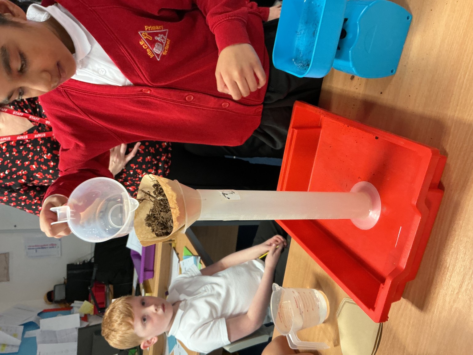 adding water and waiting to see how much water is absorbed and how much is filtered through the soil.