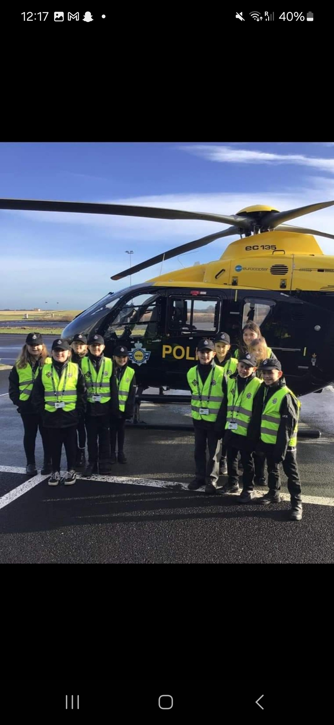 children stood with Police helicopter