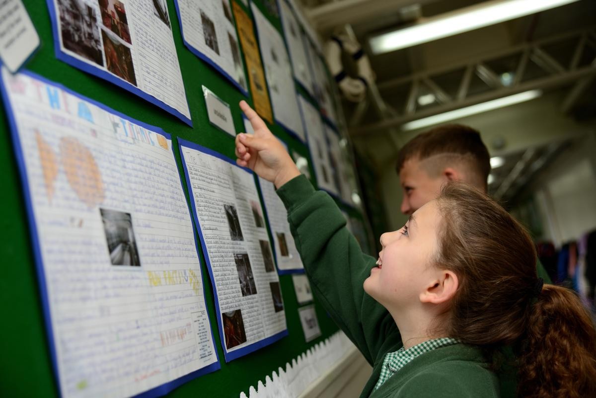 child pointing at poster