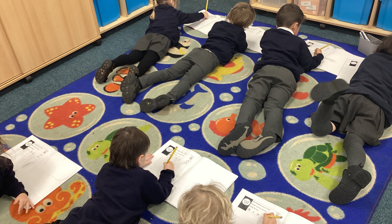 Writing in the 'Lizard' position to build core strength for writing.