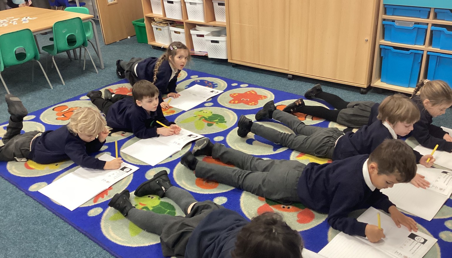 Writing in the 'Lizard' position to build core strength for writing.
