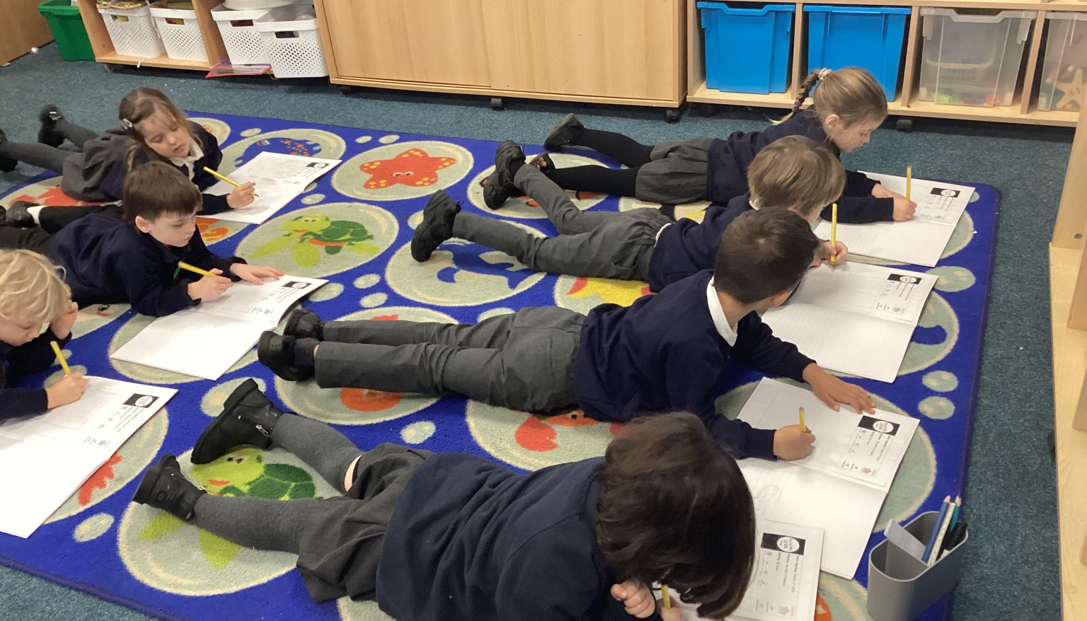 Writing in the 'Lizard' position to build core strength for writing.
