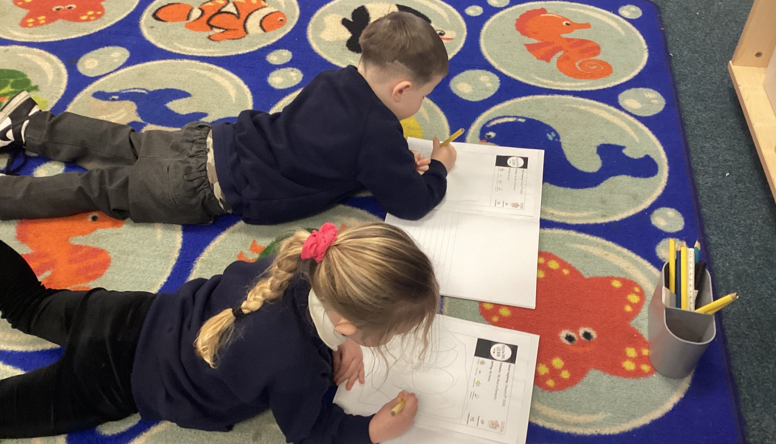 Writing in the 'Lizard' position to build core strength for writing.