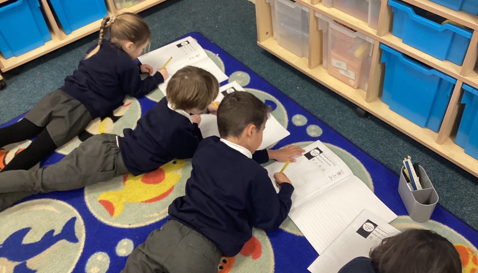 Writing in the 'Lizard' position to build core strength for writing.