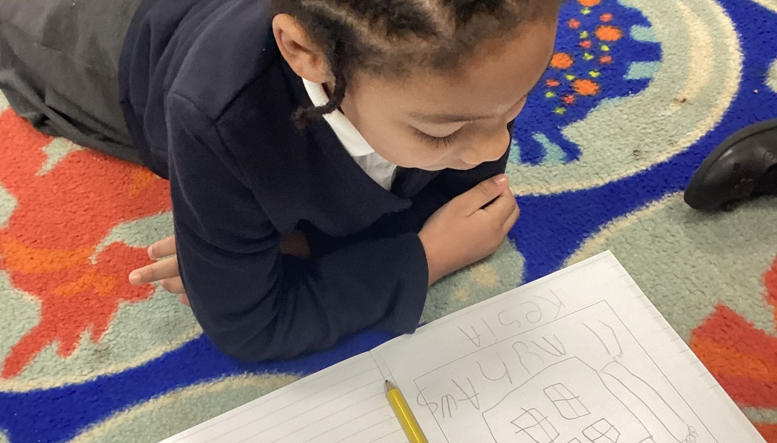 Writing in the 'Lizard' position to build core strength for writing.