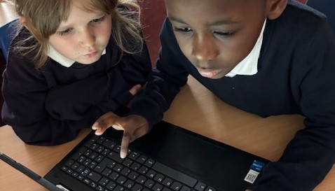 Using the laptops to find information.