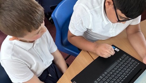 Using the laptops to find information.