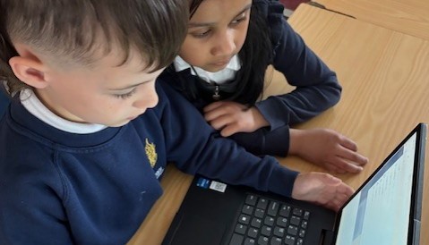 Using the laptops to find information.
