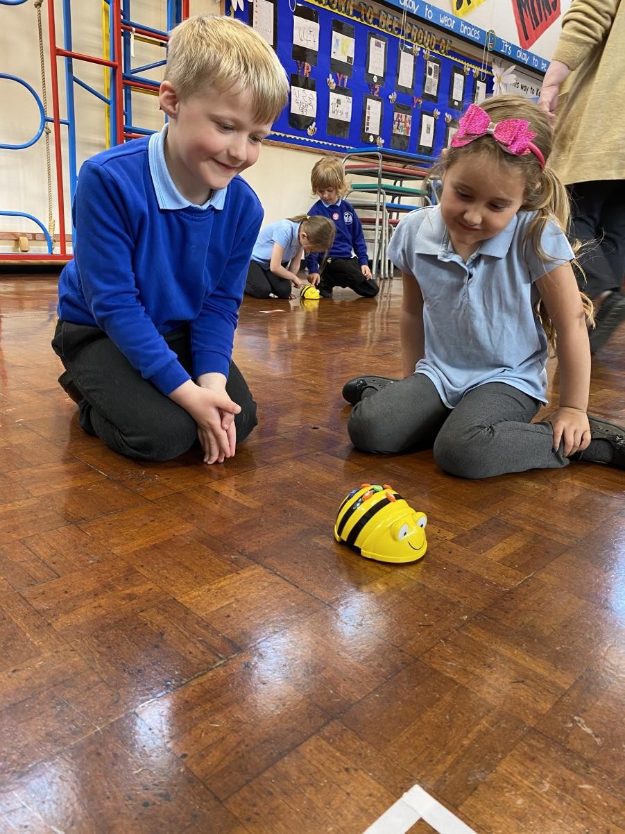 Year 1 pupils learning to program Beebots and debug their sequences of commands.