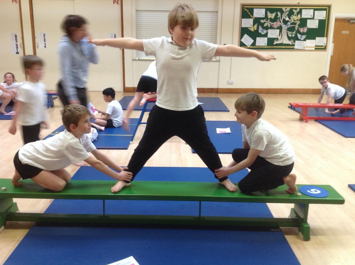 A team of 3 balance on a bench
