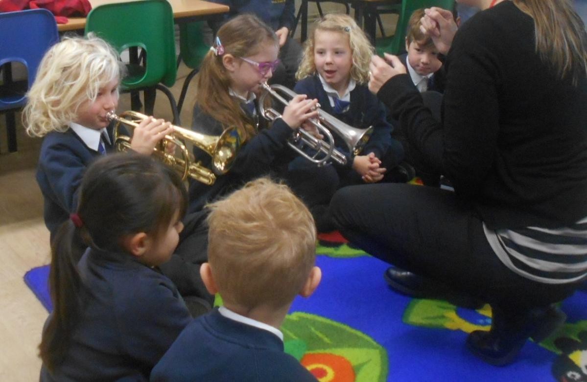 Trying the brass instruments.