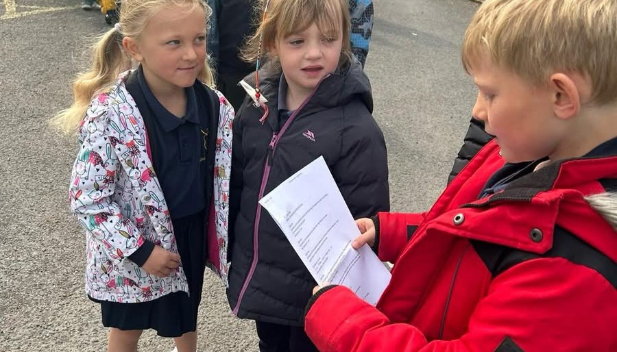 Reading our prayers whilst on our pilgrimage.
