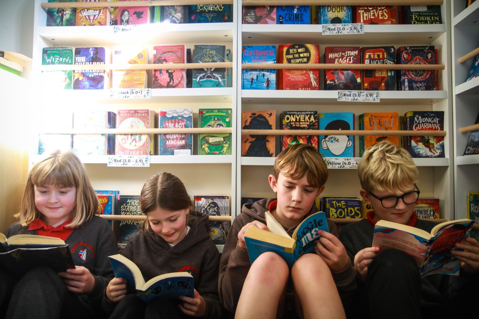 children sat reading books