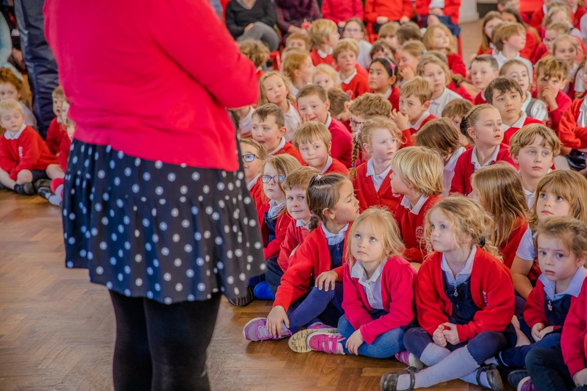 Children sat in a group in the hall