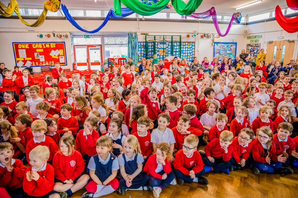 Group of children sat in hall 
