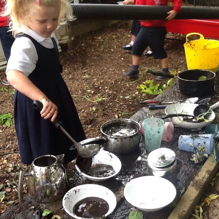 Using the mud kitchen.