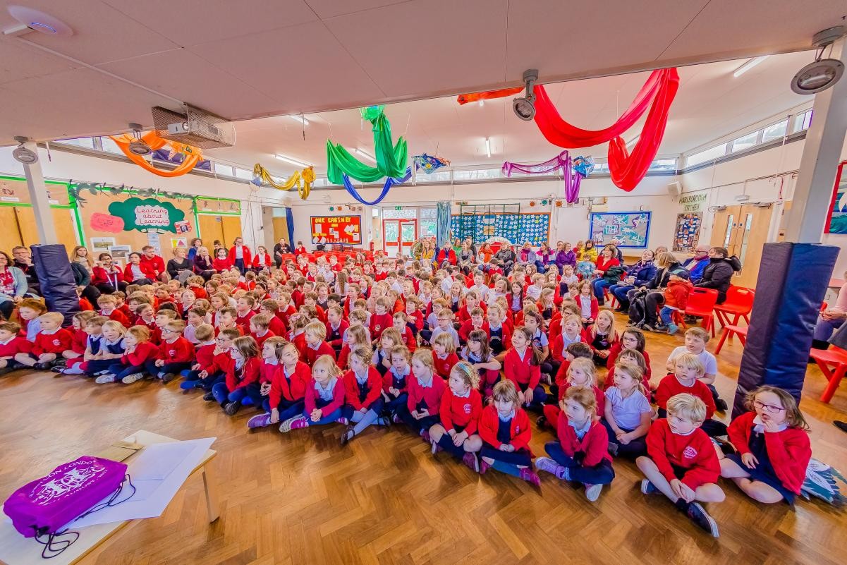 Children sat in a hall 