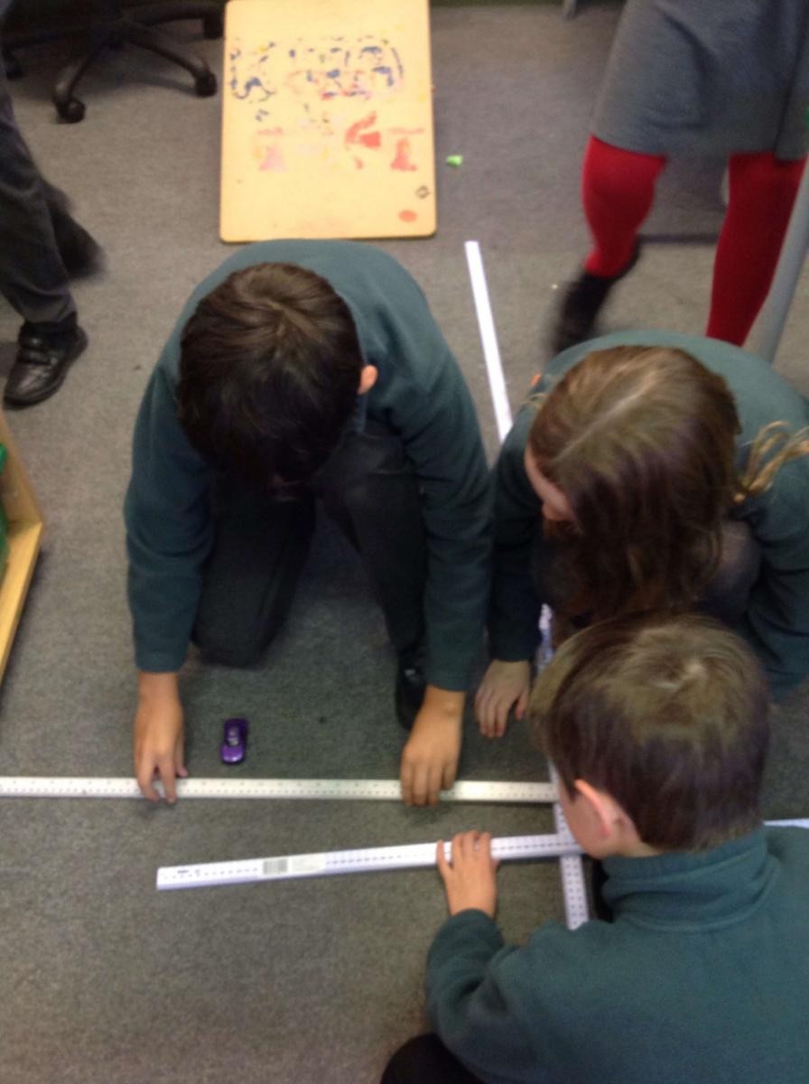 Y5 taking careful measurements in their forces topic.
