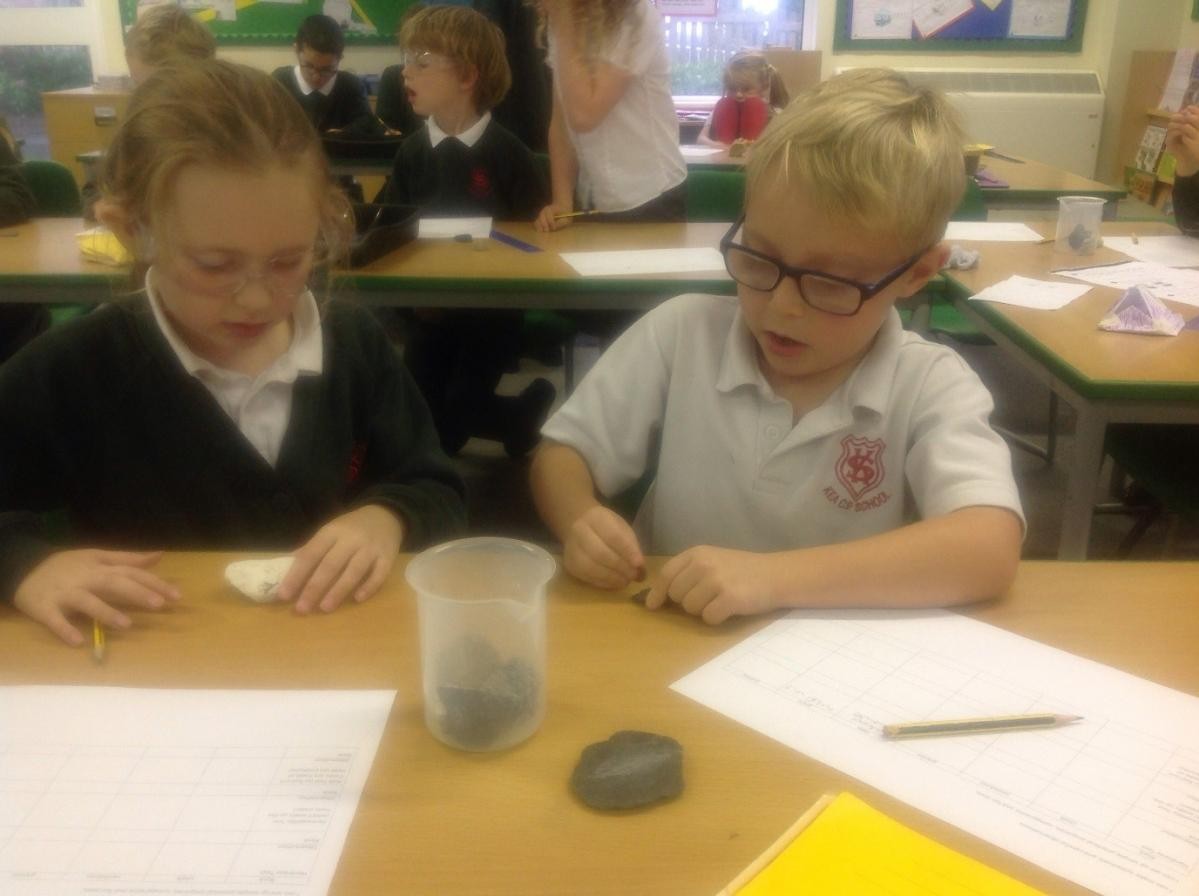 Year 3 ‘Rocks and Fossils’ testing permeability & hardness of rocks borrowed from Penair School, wearing goggles funded by Kea School Friends. 