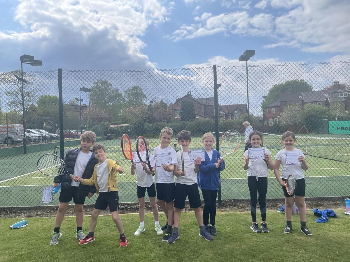 Children holding tennis rackets