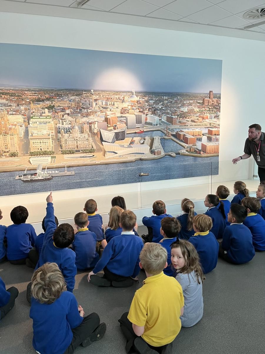 Children sat looking at a painting