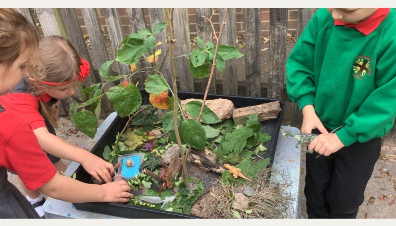 The children had fun creating a world for their dinosaur play