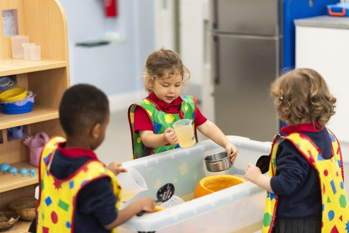 Children playing in water tray