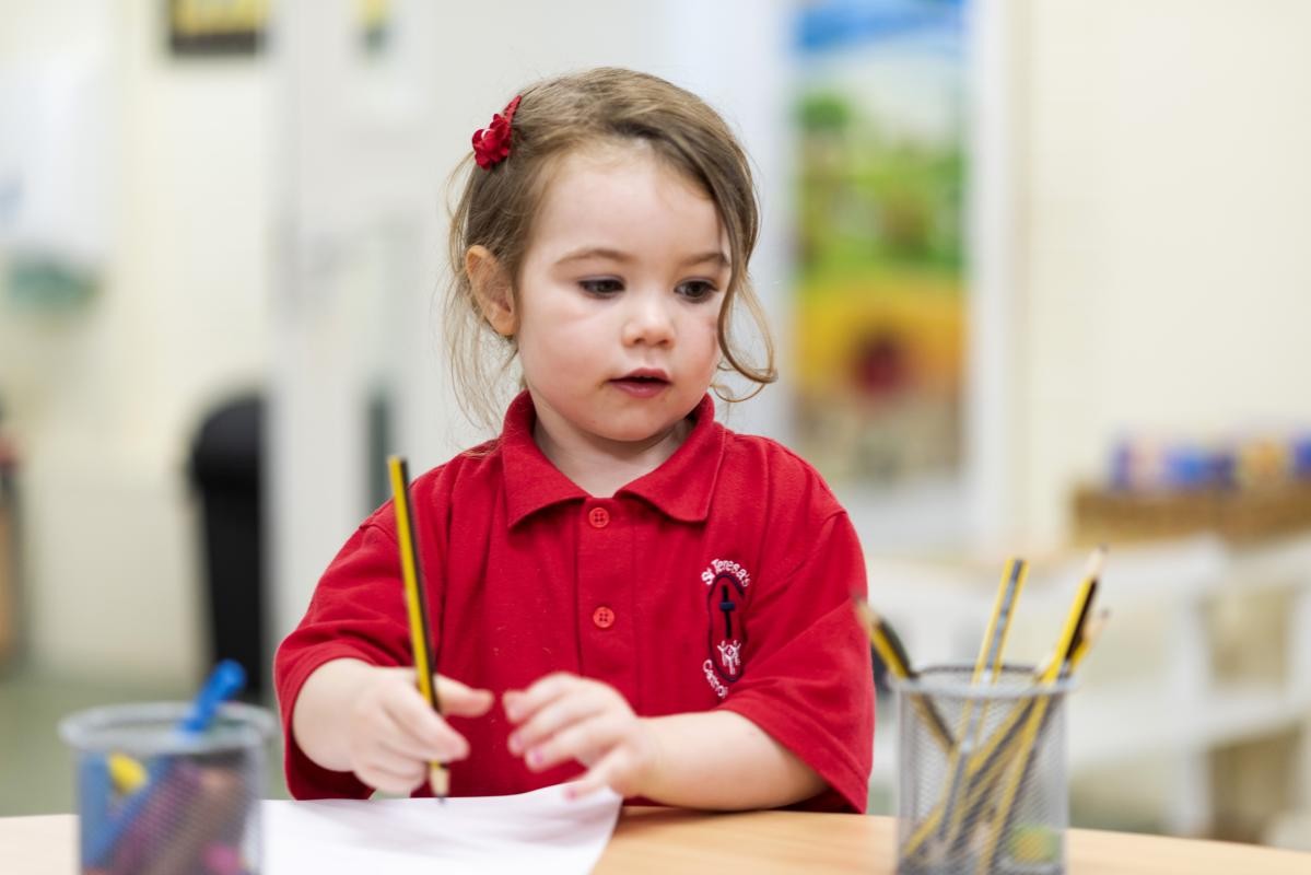 Child holding a pencil