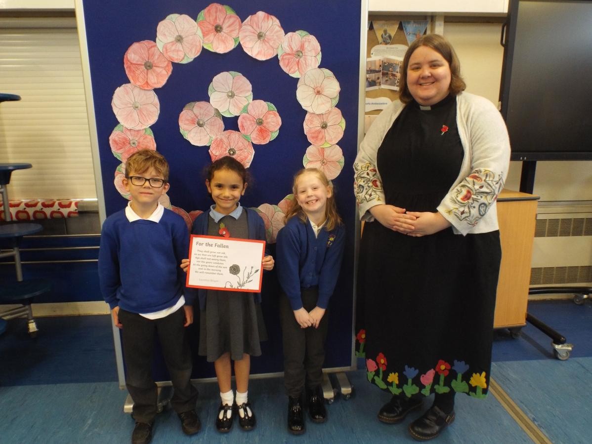 Year 2 children with Reverend Cerys