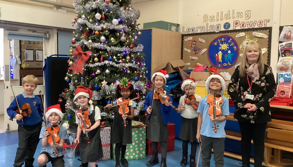 Violin students with their teacher, Alison.