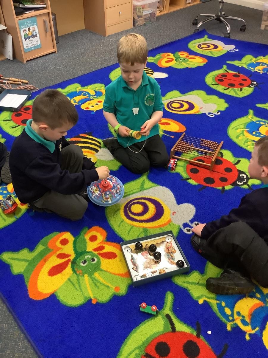 Small group work exploring old and new toys