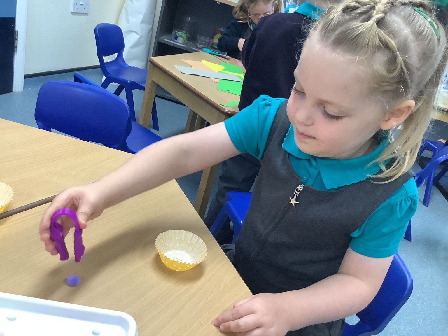 Tweezer with pom poms