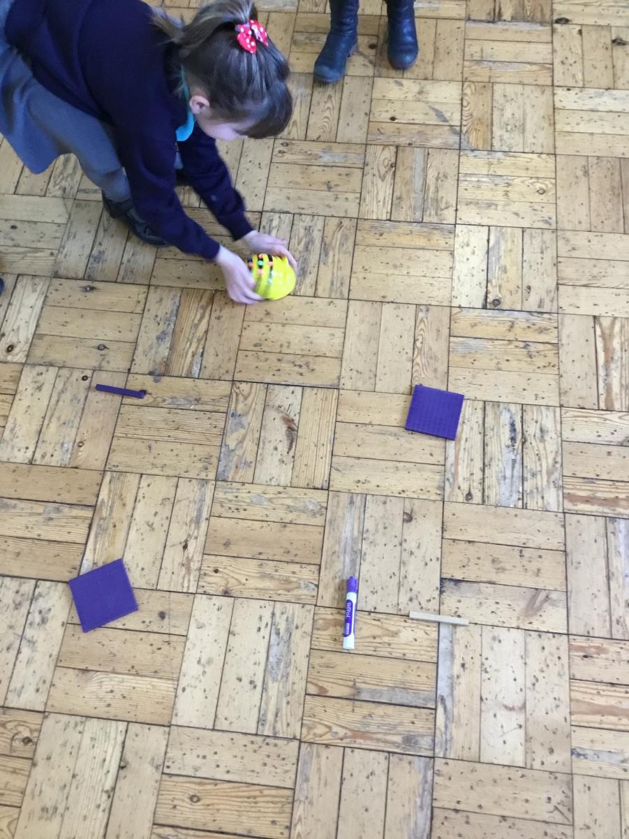 Y2 programming beebots to learn about direction.
