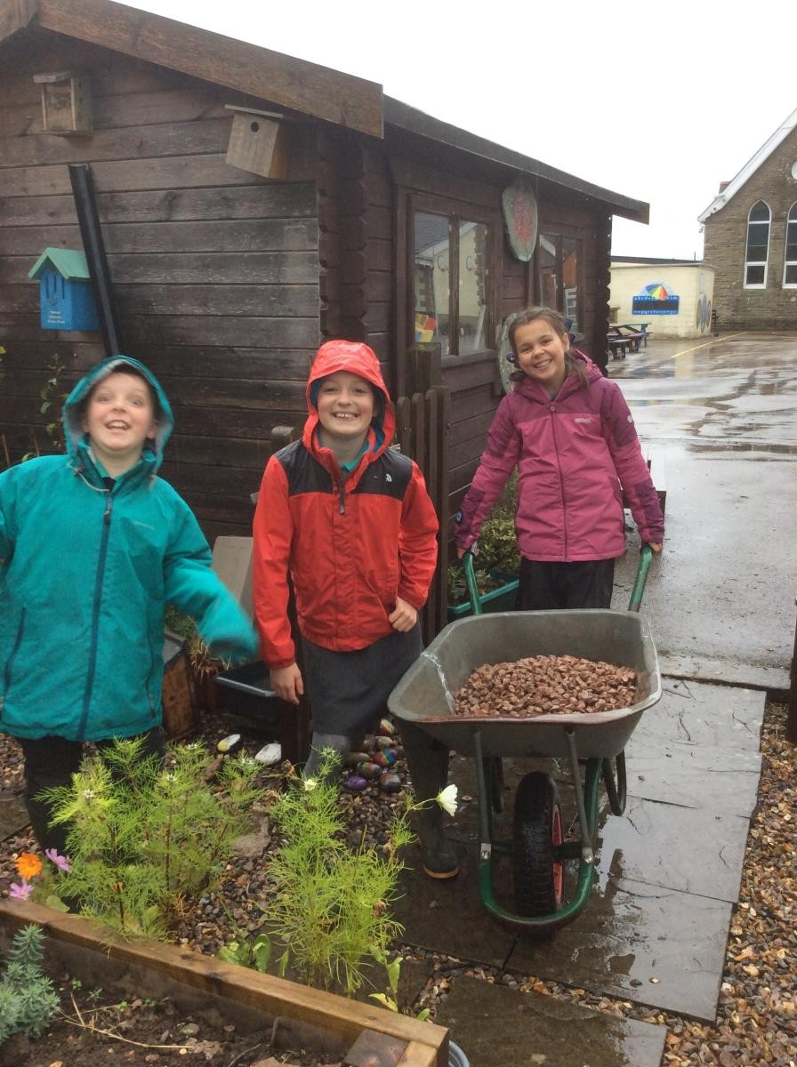 Moving gravel to make our paths better.