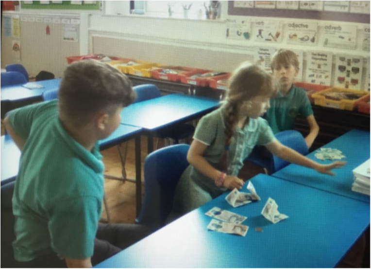 Members of the School Council helping to count the money raised.