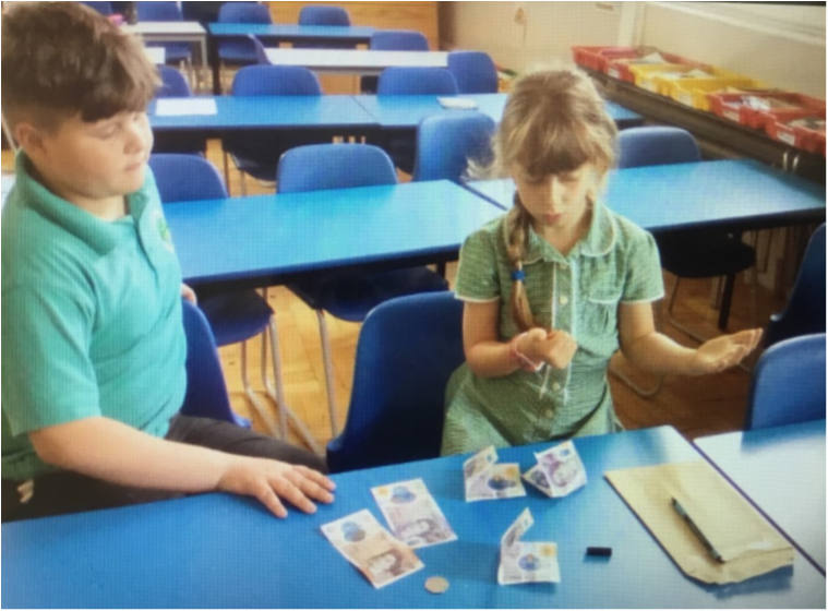 Members of the School Council helping to count the money raised.