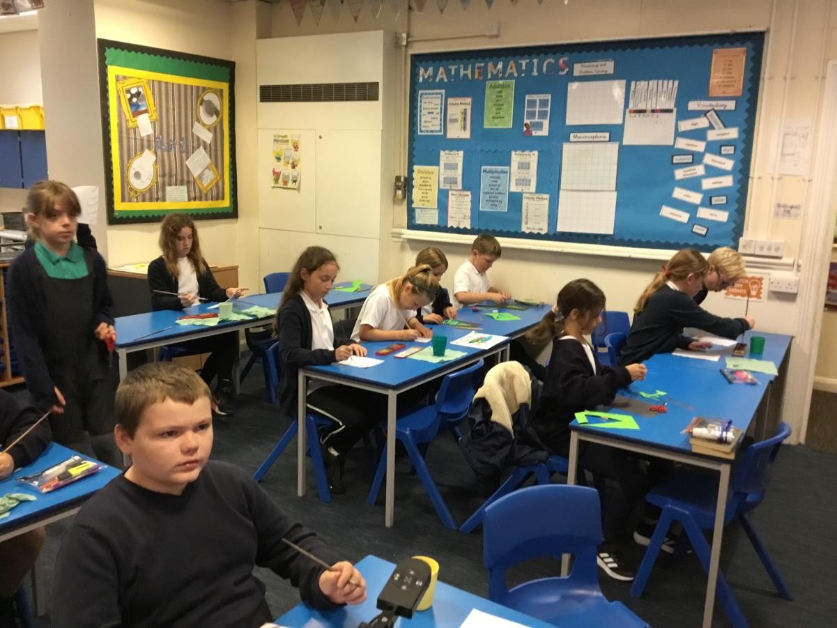 Children creating posters with tips on how to stay safe online. 