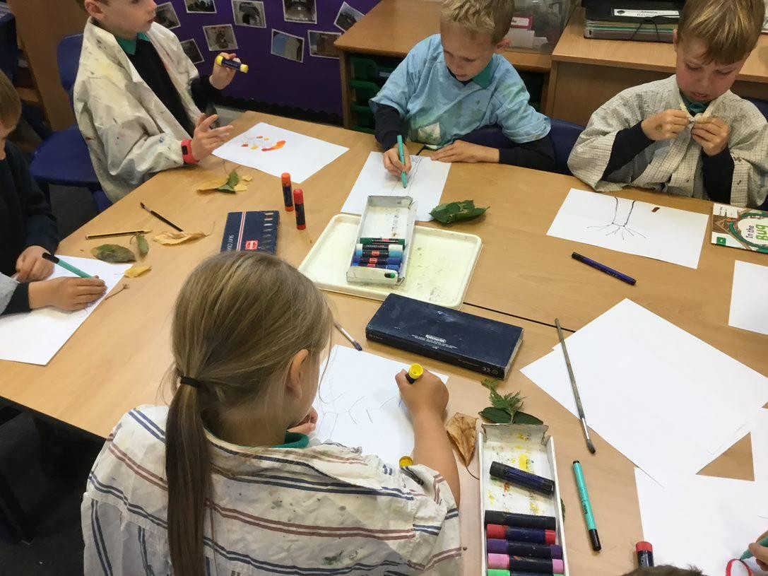 We experimented with autumn colours using silk crayons.