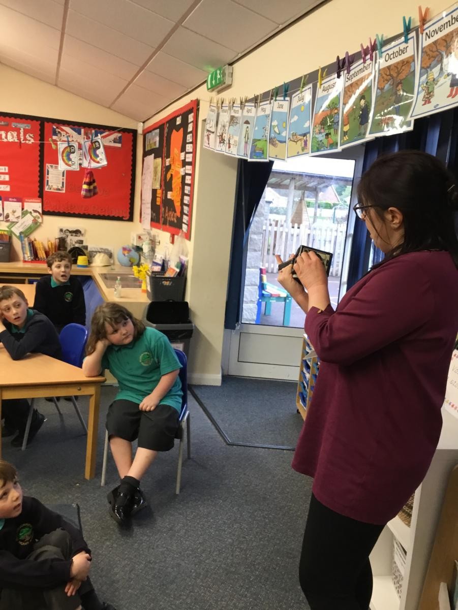 Mrs Aston showing the children an old camera 