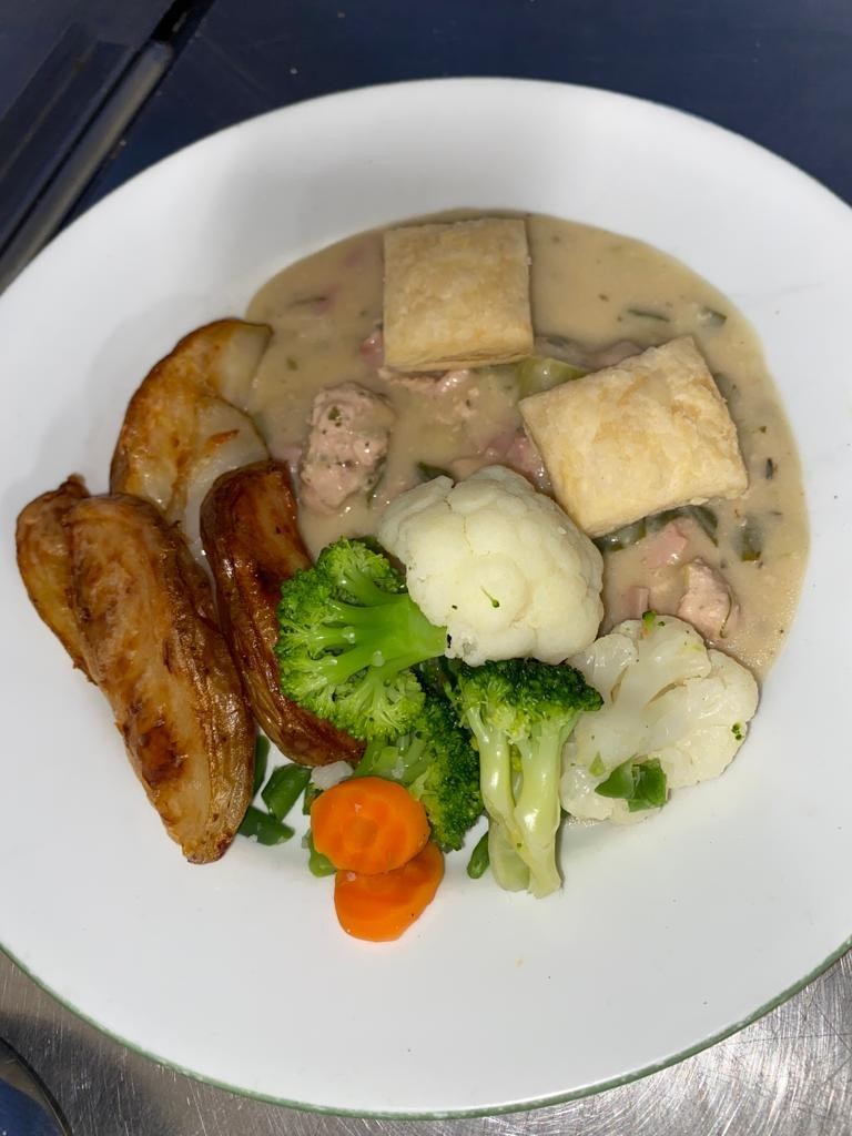 Chicken, ham and leek pie with potato wedges and vegetables