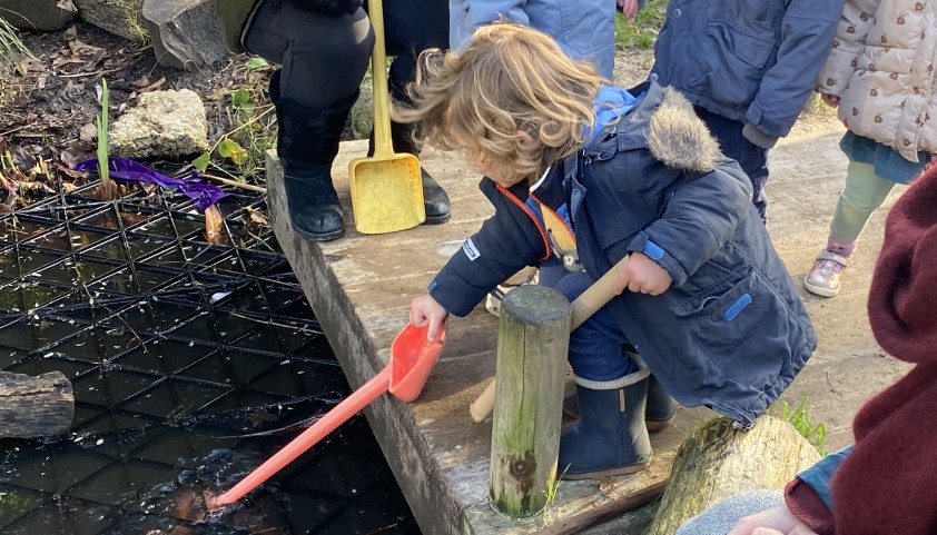 Child finds something in the pond