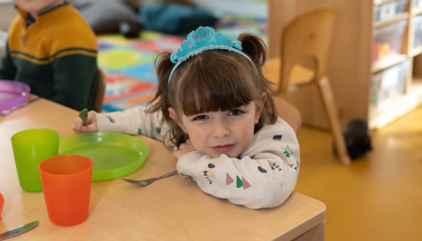 Little girl seated at the table