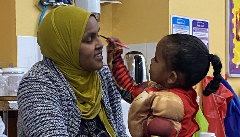 Child applies his mother's makeup