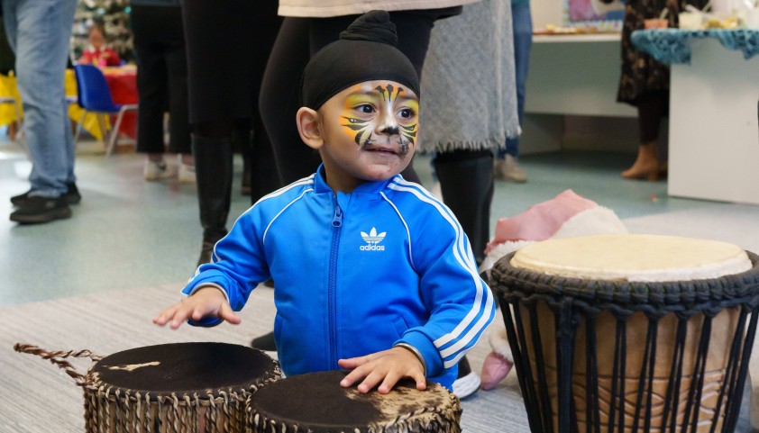 Young boy playing with drums