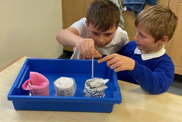 Crenver experimenting to discover which material is the best insulator.
