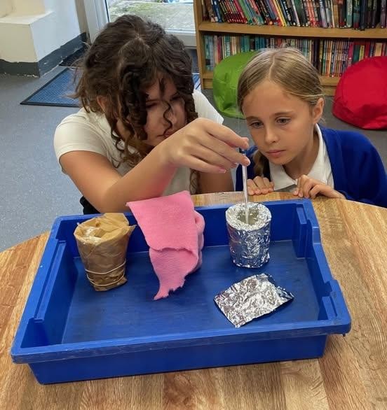 Crenver experimenting to discover which material is the best insulator.