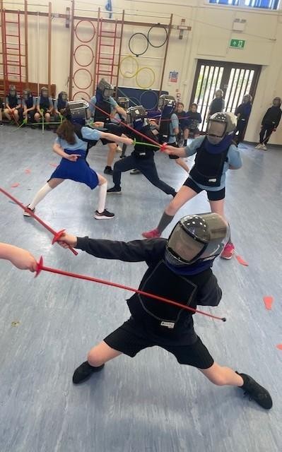 Crenver learning the new sport of fencing. 