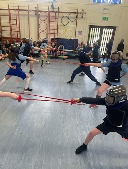 Crenver learning the new sport of fencing. 