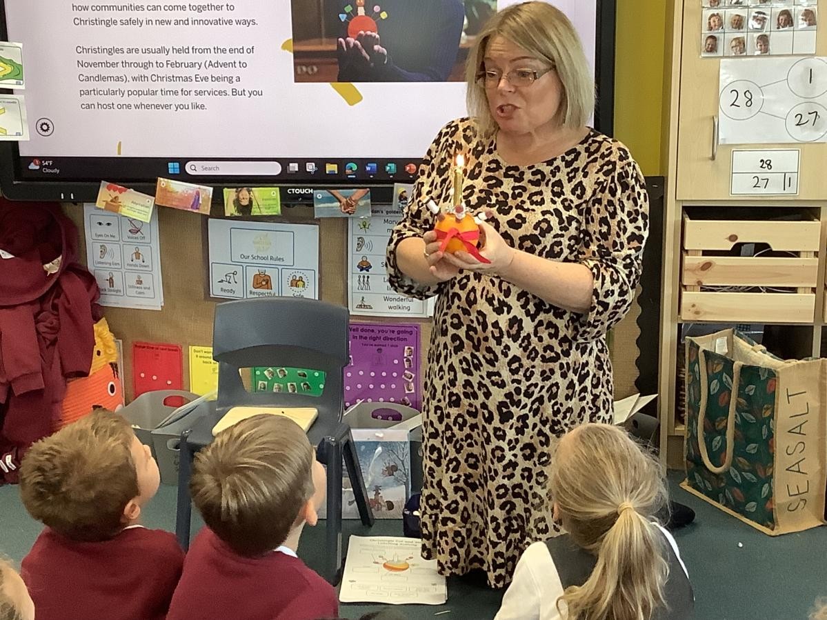 Year 1: Learning the meaning behind Christingles with a member of the local church