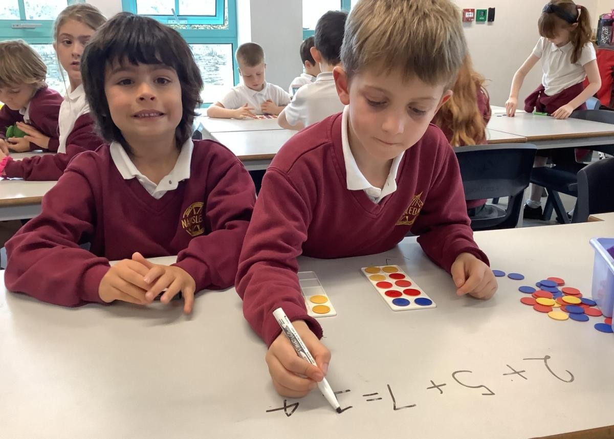 Learning to add 3 one-digit numbers.